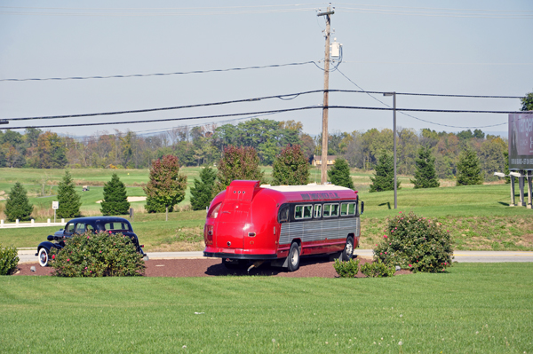 An old bus and antique car