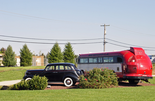 An old bus and antique car