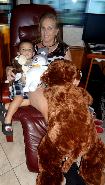 Karen Duquette and her great-grandson, plus cowboy the giant monkey, Chuckles the little monkey, and Frosty the snowman