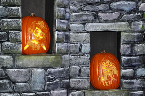 carved pumpkins in a window