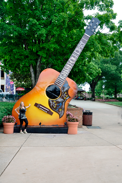 Karen Duquette by a guitar at the entrance to Grand Ole Opry