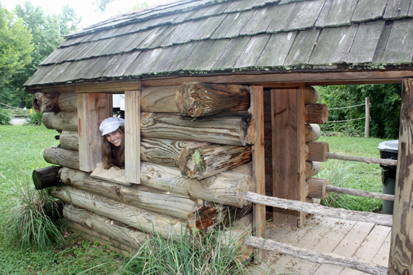 Karen inside the log cabin