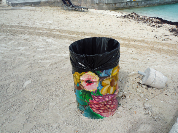 painted trash can on the beach