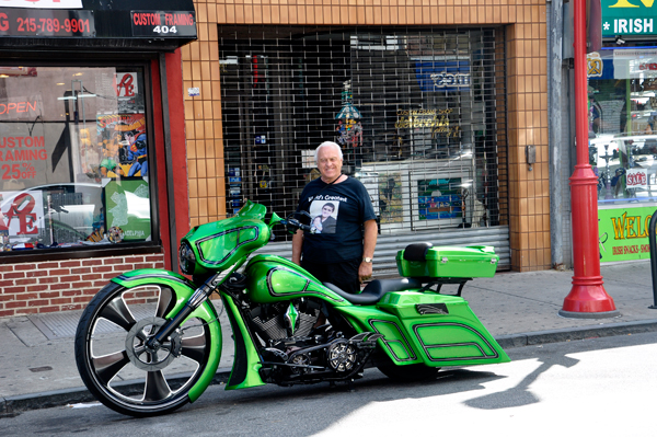 Lee Duquette by a greeen motorcycle