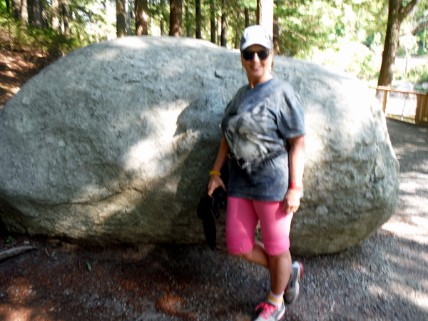 Karen Duquette stands by the Anorthosite Boulder
