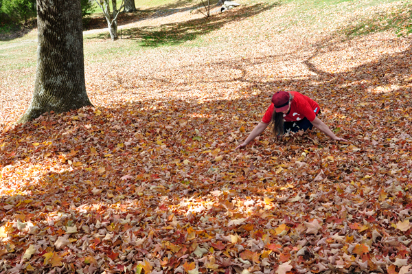 Karen Duquette playing in the fall leaves