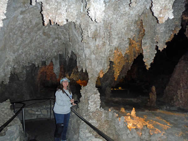 Karen Duquette inside near a column in Carlsbad Cavern