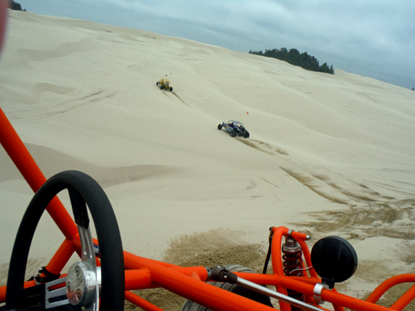 Dune buggies heading up the dune