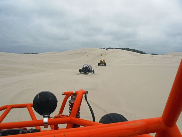 Dune buggies heading up the dune