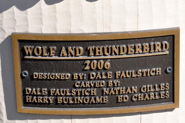 sign: Wolf and Thunderbird totem pole