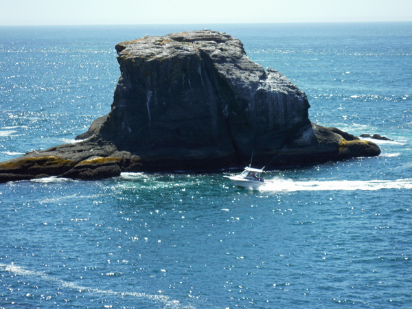 a boat and a big rock island