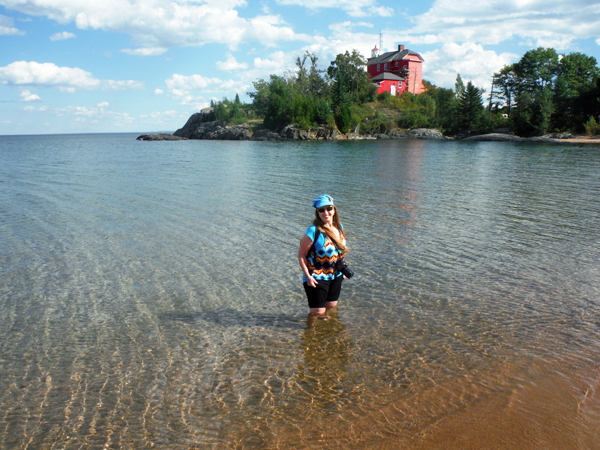 Karen Duquette wades in Lake Superior by Marquette Lighthouse