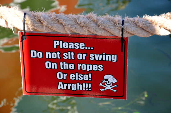 do not sit on ropes sign