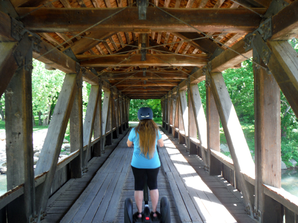 Karen Duquette riding the Segway through Lone Pine Crossing Covered Bridge
