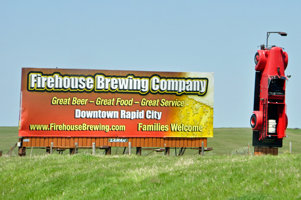 Firehouse Brewing Company sign and firetruck upside down