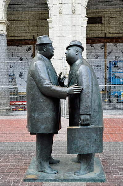 statue of two businessmen