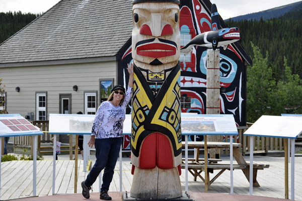 Karen Duquette at the base of the totem pole