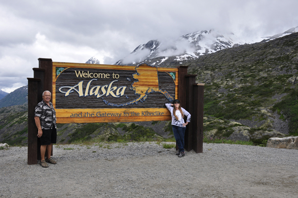 the two RV Gypsies at the Welcome to Alaska sign