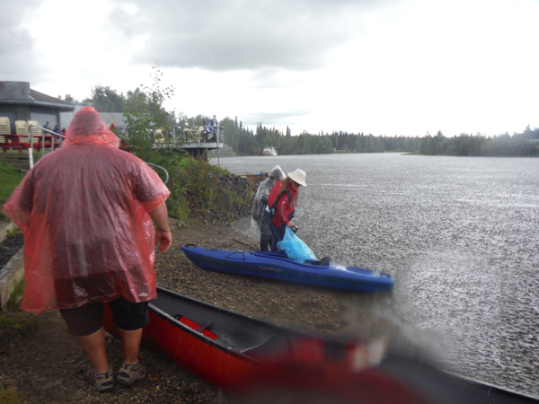 John and Karen parking kayaks in the rain