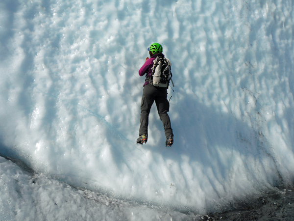 guide climbing a sheet of ice