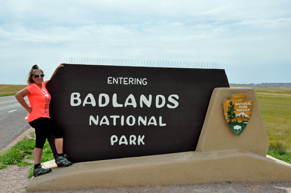 Karen Duquette at Badlands NP entrance sign