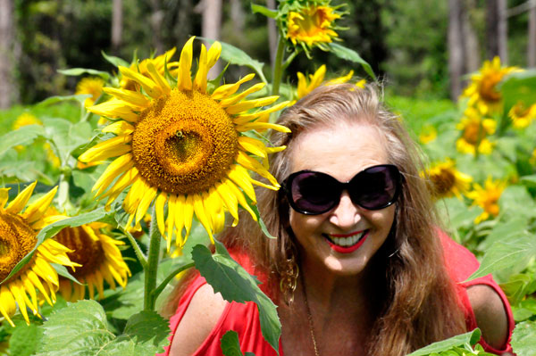 Karen Duquette in a field of sunflowers