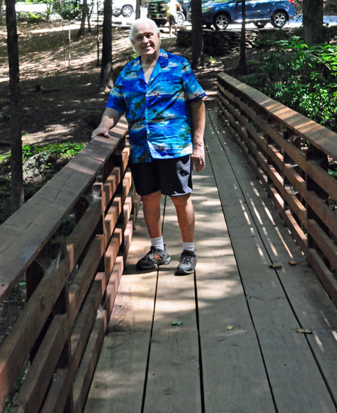 Lee Duquette on a short wooden bridge