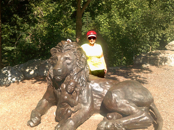 Karen Duquette and a lion statue