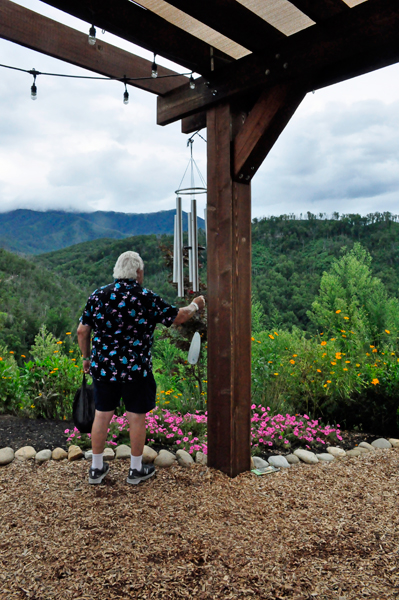 Lee Duquette plays with the giant wind chimes