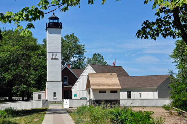 Presque Isle Lighthouse and the U.S.A. Flag as sen from the beach