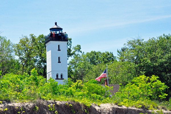 Presque Isle Lighthouse and the U.S.A. Flag as seen from the beach