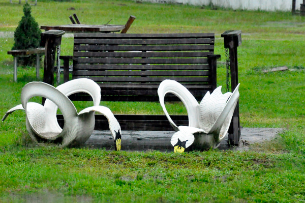 2 swans made out of old lawn chairs