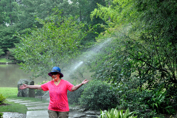 Karen Duquette in the sprinkler