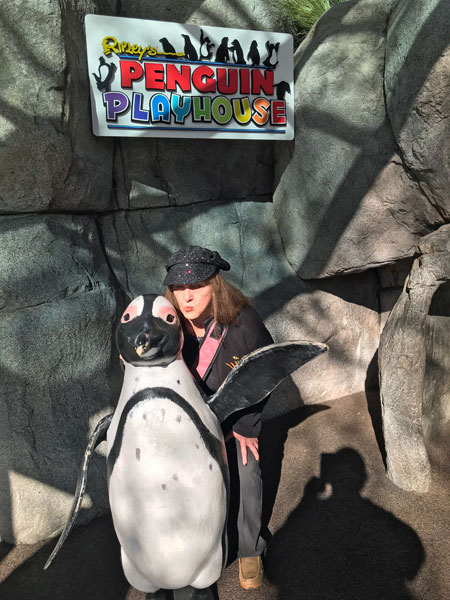 Karen Duquette and a Penguin statue