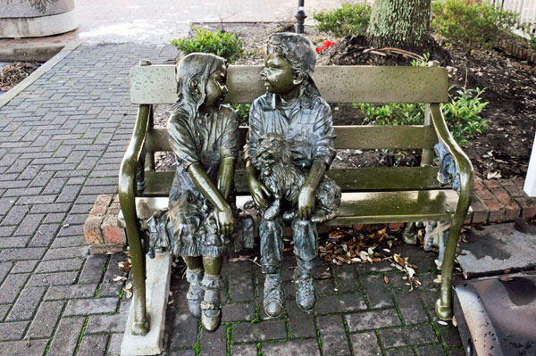 children statues on a bench