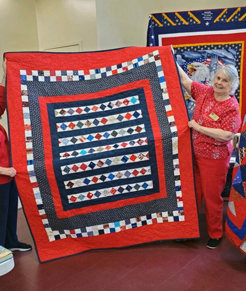 Joanie Bolton with Lee Duquette's Quilt of Valor