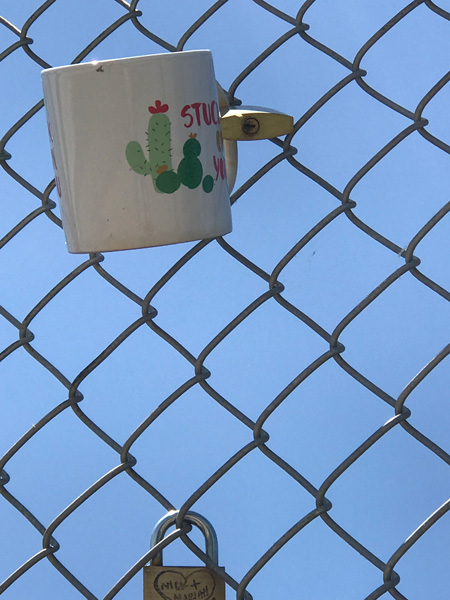 a coffee cup on the fence