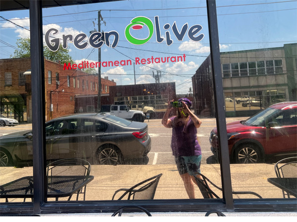 Karen Duquette at the Green Olive  Restaurant window