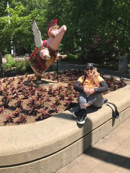 Karen Duquette and a winged pig statue