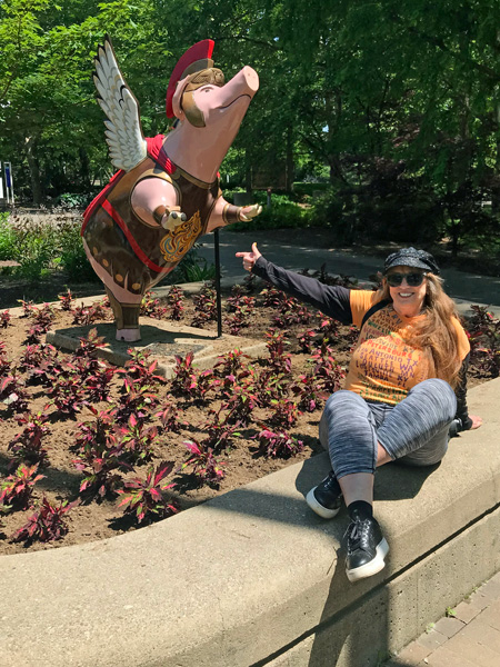 Karen Duquette and a winged pig statue