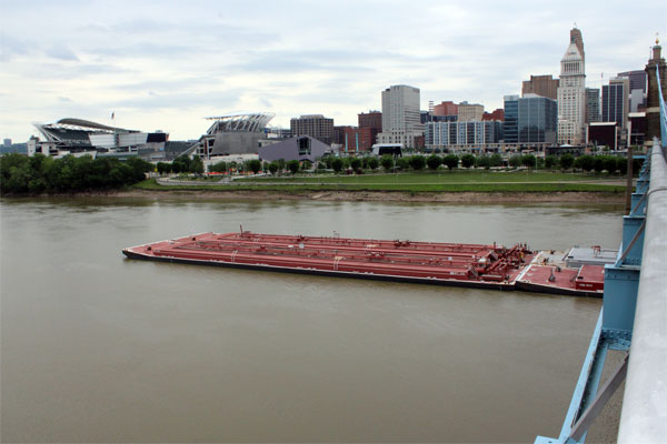 barge emerging out from under the bridge