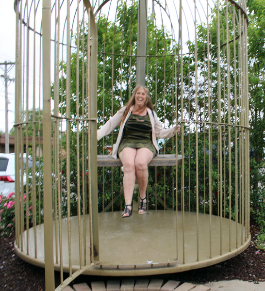 Karen Duquette in a bird cage