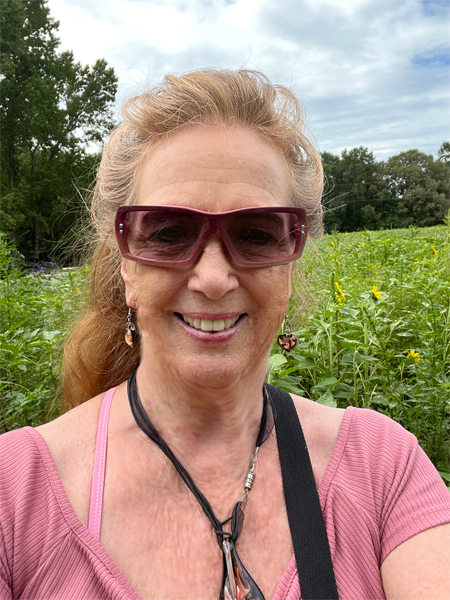 Karen Duquette in the sunflower field