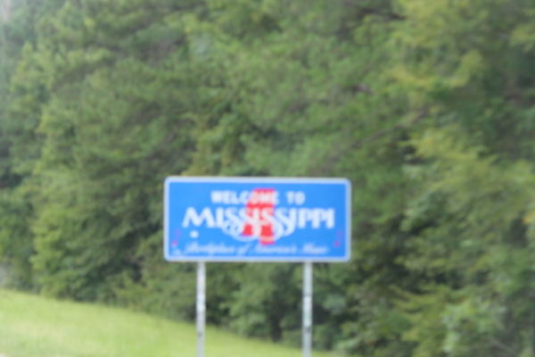 a blurry welcome to Mississippi sign