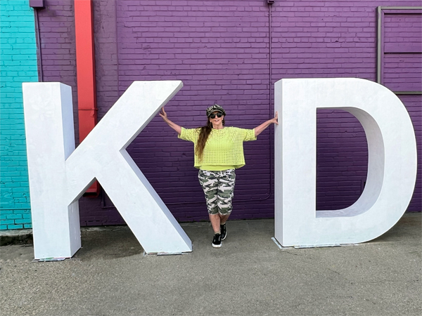 Karen Duquete at a big KD sign
