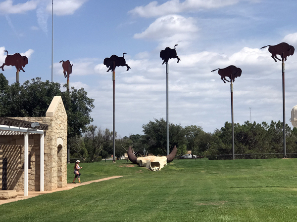 Karen Duquette at the buffalo wind vanes and a buffalo skull
