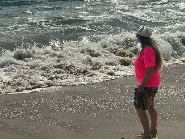 Karen Duquette at West Jetty Beach with big waves