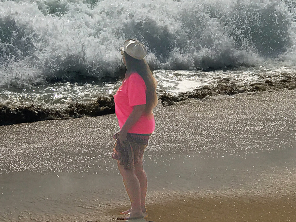 Karen Duquette at West Jetty Beach with big waves 