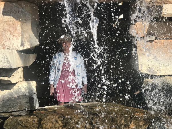 Karen Duquette behind the waterfall