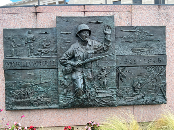 bronze panel representing World War II